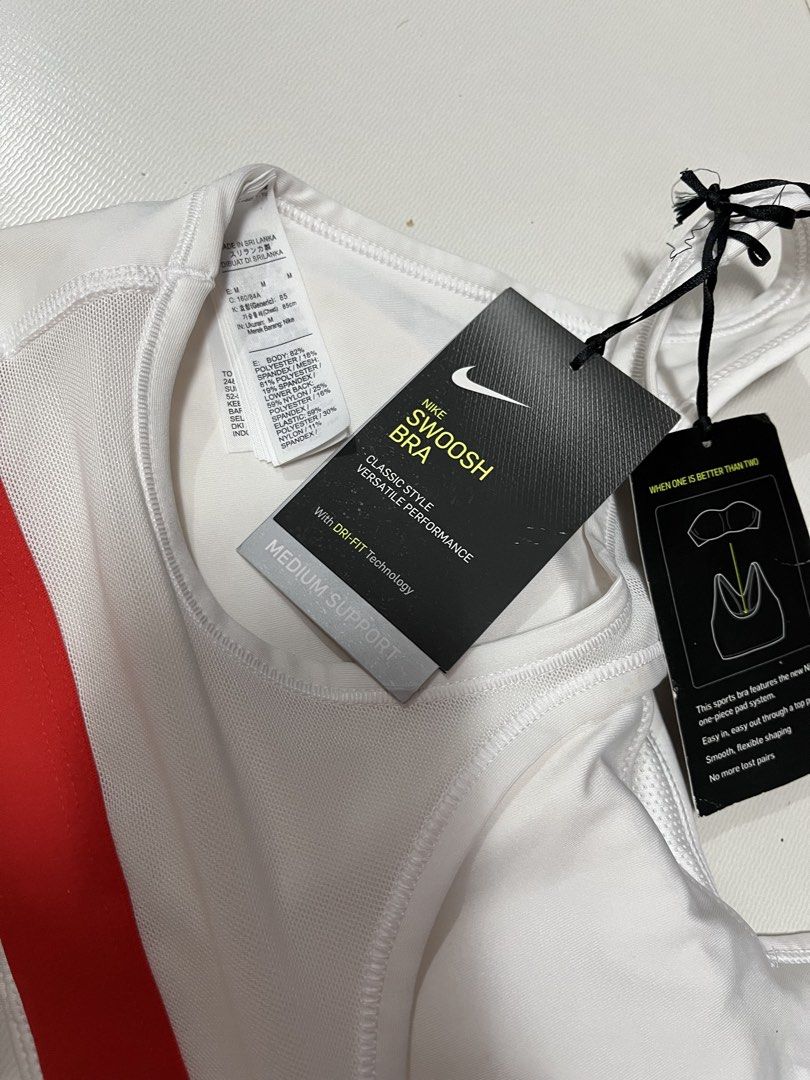 Nike Swoosh Medium Support Sports Bra White Medium (Category: Activewear) located in Manila. Submitted by cheng2007 (Listing ID 1468809797, Image 3). Description: - Brand: Nike - Style: Swoosh sports bra with red and blue graphic logo - Color: White - Size: Medium (approx. 12 inches across chest) - Support: Medium support with Dri-FIT technology - Features: Breathable mesh back panel - Condition: Brand new with original tags still attached 📍FLAW