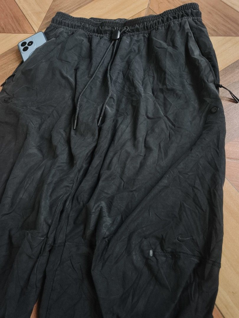 Nike Tech Fleece Black Track Pants (Category: Joggers) located in Zamboanga. Submitted by d2977250664046 (Listing ID 1468880354, Image 2). Description: - Brand: Nike Tech Fleece - Color: Black - Size: Large (32-34x38.5) - Condition: Great casual streetwear piece - Features: Elastic waistband with drawstring, secure zippered side pockets, and adjustable bungee drawcord cuffs - Origin: Made in China - Excellent (NeedWash).