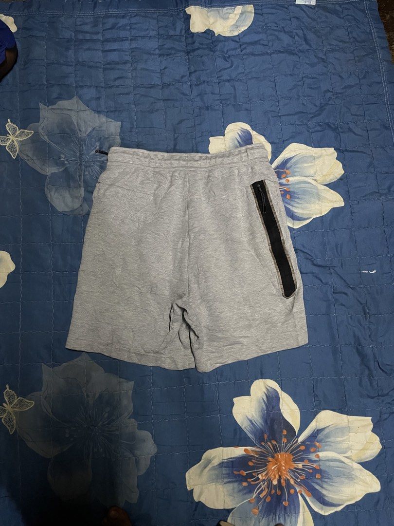Nike Tech Fleece Grey Shorts Size S (Category: Shorts) located in Manila. Submitted by chawmichael (Listing ID 1468880010, Image 2). Description: - Brand: Nike - Style: Tech Fleece Shorts - Color: Grey - Size: Small - Origin: Made in Vietnam - Condition: Great overall condition - Features: Adjustable drawstring waistband, secure side zipper pocket, and iconic Nike leg logo - Ideal for: Daily casual wear or workouts.