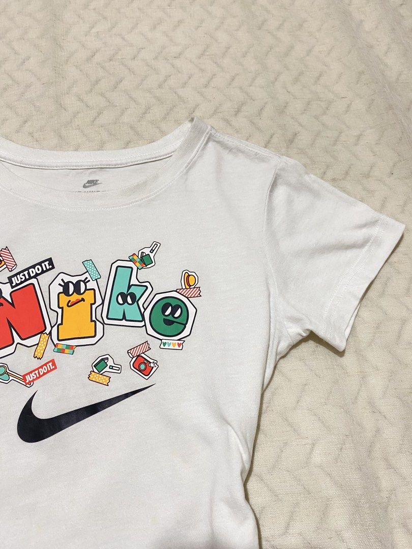 Nike White Graphic Baby Tee (Category: Shirts) located in Marilao. Submitted by kyssmarila (Listing ID 1468884445, Image 2). Description: — Size: S on tag — Dimes: 15x18 — Flaws: yellow stain (not noticeable and can wash) .