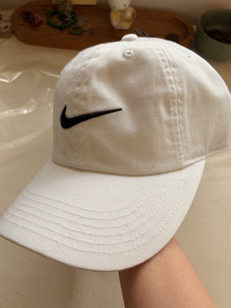Nike White Kids Cap (Category: Caps & Hats) located in Makati City. Submitted by bingjumnl (Listing ID 1468762677, Image 2). Description: - Authentic Nike baseball cap for kids - Color: Clean white cotton fabric - Design: Classic embroidered black swoosh logo on the front - Fit: Adjustable strap at the back for a custom fit - Condition: Brand new with tags (BNWT), original retail price sticker inside brim.