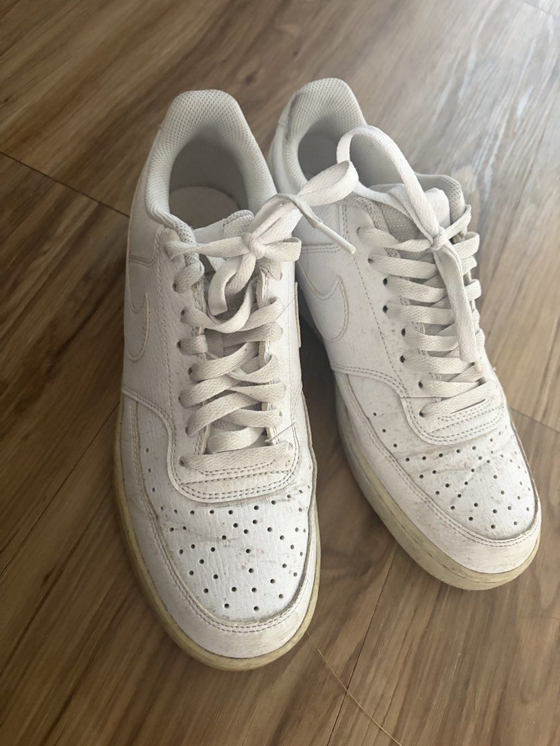 Nike White Low Top Sneakers (Category: Sneakers) located in Bacoor. Submitted by quentinz (Listing ID 1468781041, Image 2). Description: - Style: Classic white low-top sneakers with iconic swoosh branding - Features: Perforated toe boxes and comfortable textured collar padding - Condition: Soles have minor yellowing from age and regular wear - Versatility: Great everyday casual kicks that go with almost anything.