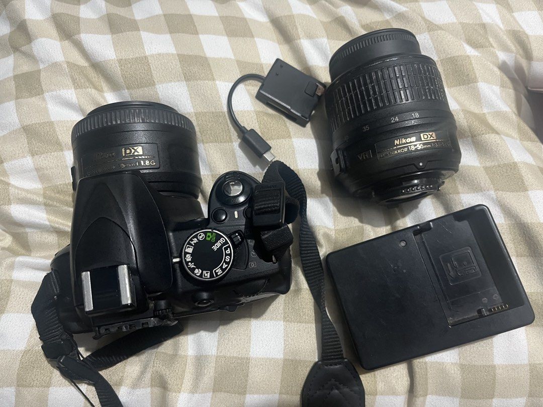 Nikon D3100 DSLR + 2 Lenses (Category: Cameras) located in Paranaque City. Submitted by paddylla44 (Listing ID 1468922597, Image 1). Description: What you see is what you get Inclusions: - Nikon D3100 camera body - Nikon AF-S DX NIKKOR 35mm f/1.8G lens - Nikon AF-S DX NIKKOR 18–55mm f/3.5–5.6G lens - Battery & Charger - Bag Condition: - Both lenses are usable. - LCD has vignette/dark areas. - Camera displays “Error. Press shutter release button a