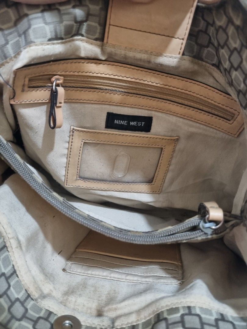 Nine West Monogram Pattern Shoulder Bag with Buckle Straps (Category: Shoulder Bags) located in Quezon City. Submitted by gabdclutz (Listing ID 1468838805, Image 3). Description: - Brand: Nine West - Design: Brown and tan geometric print with light tan leather trim - Straps: Double shoulder straps with stylish buckle details - Closure: Magnetic snap closure - Interior: Light fabric lining with zip pocket, slip pockets, and card slots - Flaw: Noti