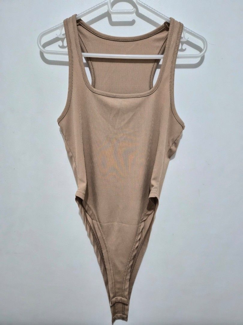 Nude ribbed racerback bodysuit (Category: Sleeveless) located in Mandaluyong City. Submitted by joyce1593 (Listing ID 1468818094, Image 1). Description: - Color: Neutral beige (goes with everything) - Style: Sleeveless, racerback, scoop neckline - Fabric: Ribbed, stretchy, and comfortable - Fit: Form-fitting with convenient bottom snap closure - Perfect for: Everyday layering under jeans or skirts.