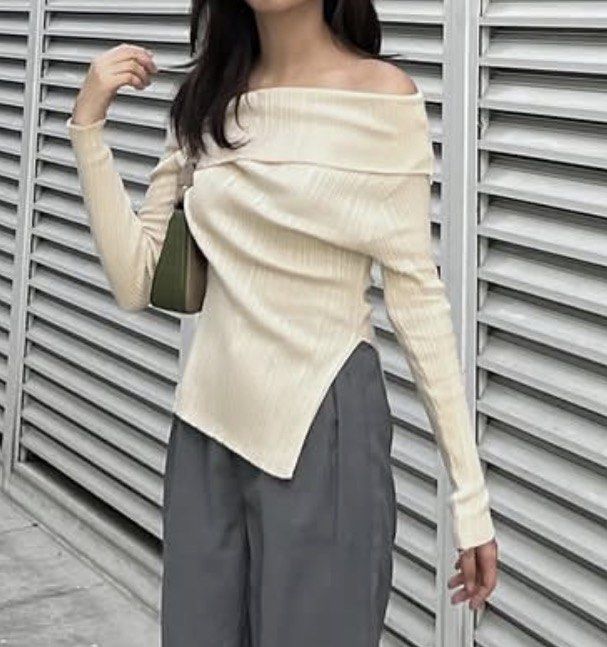 Off-shoulder ribbed knit sweater cream top (Category: Longsleeves) located in Manila. Submitted by rumyewn (Listing ID 1468790699, Image 1). Description: - Color: Cream - Style: Folded off-shoulder neckline with long sleeves and asymmetrical hem - Texture: Ribbed knit with soft stretch material - Versatility: Great basic for layering or wearing solo in cooler weather - Pairing: Matches well with both trousers and skirts.