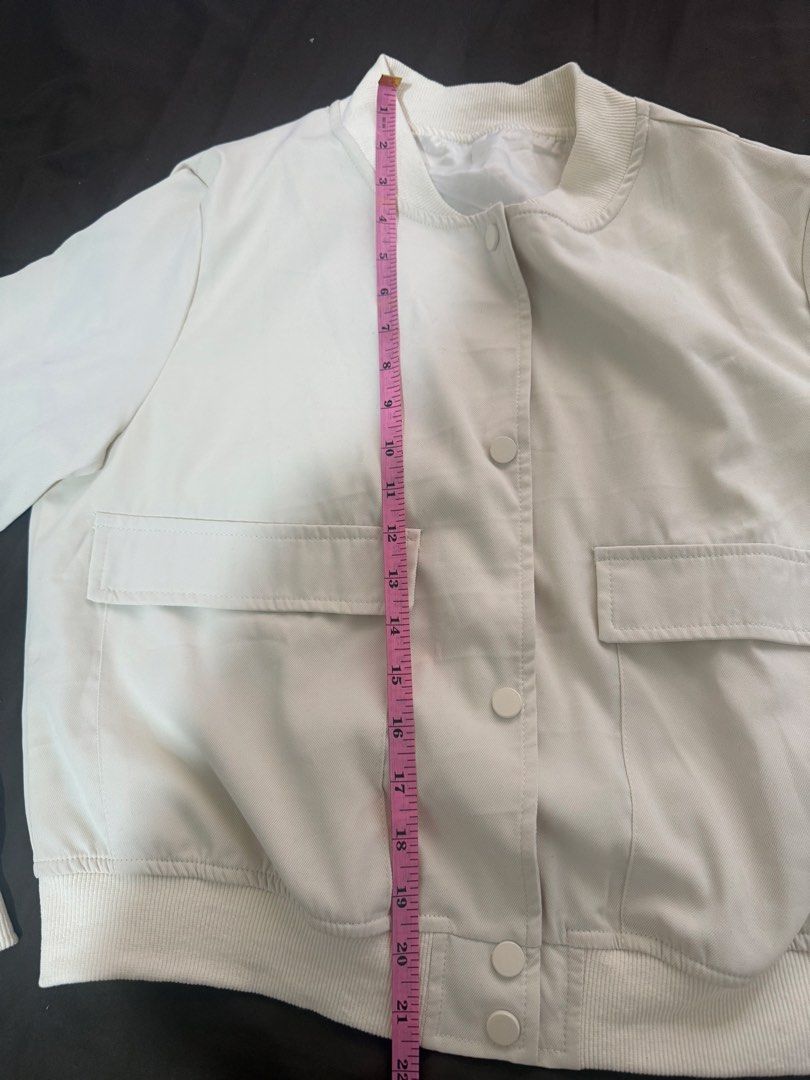 Off-White Bomber Jacket with Flap Pockets and Snap Buttons (Category: Coats, Jackets and Outerwear) located in Quezon City. Submitted by turtleandfishes (Listing ID 1468734202, Image 2). Description: - Color: Off-white - Material: Lightweight and easy to layer - Closure: Snap button front - Pockets: Two front flap pockets at the chest - Details: Ribbed collar, cuffs, and hem - Measurements: Pit to pit ~21 inches, Length ~22 inches.
