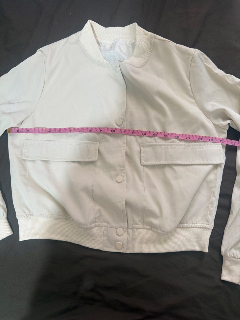 Off-White Bomber Jacket with Flap Pockets and Snap Buttons (Category: Coats, Jackets and Outerwear) located in Quezon City. Submitted by turtleandfishes (Listing ID 1468734202, Image 3). Description: - Color: Off-white - Material: Lightweight and easy to layer - Closure: Snap button front - Pockets: Two front flap pockets at the chest - Details: Ribbed collar, cuffs, and hem - Measurements: Pit to pit ~21 inches, Length ~22 inches.