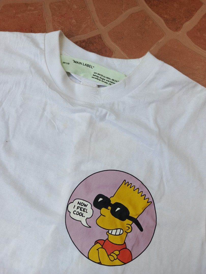 Off-White Virgil Abloh Bart Simpson Public Enemy T-shirt (Category: Tshirts & Polo Shirts ) located in Dipolog. Submitted by just_thriftfinds (Listing ID 1468750606, Image 3). Description: - Brand: Off-White (with Virgil Abloh Main Label neck tag) - Material: Premium white cotton - Condition: Good, with a small faint yellowish stain near the front collar area - Style: Rare streetwear collectible Dimes: 18/25.
