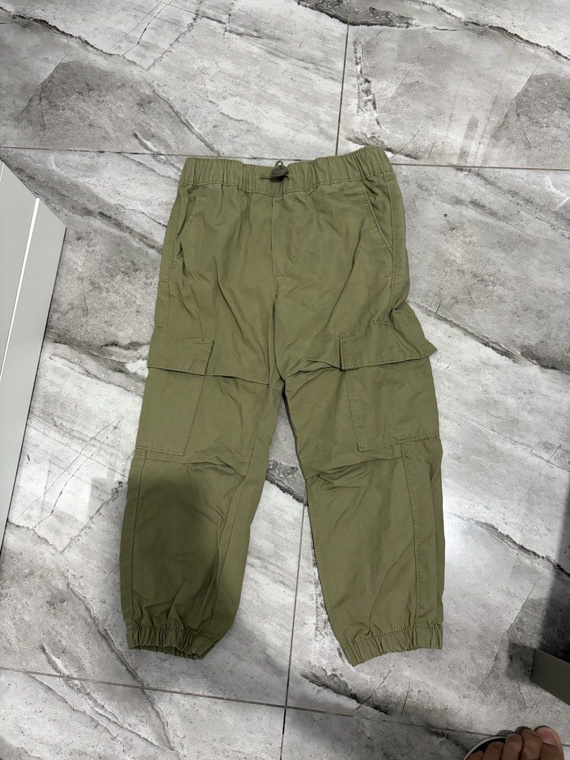 Olive Green Cargo Jogger Pants with Cuffs (Category: Babies & Kids Fashion) located in Bulacan. Submitted by lenggayy (Listing ID 1468802191, Image 1). Description: - Color: Green - Fit: Relaxed fit through the legs with elastic cuffs - Waistband: Elastic with adjustable drawstring - Pockets: Multiple functional pockets on sides and thighs - Style: Great for casual everyday wear and outdoor activities.