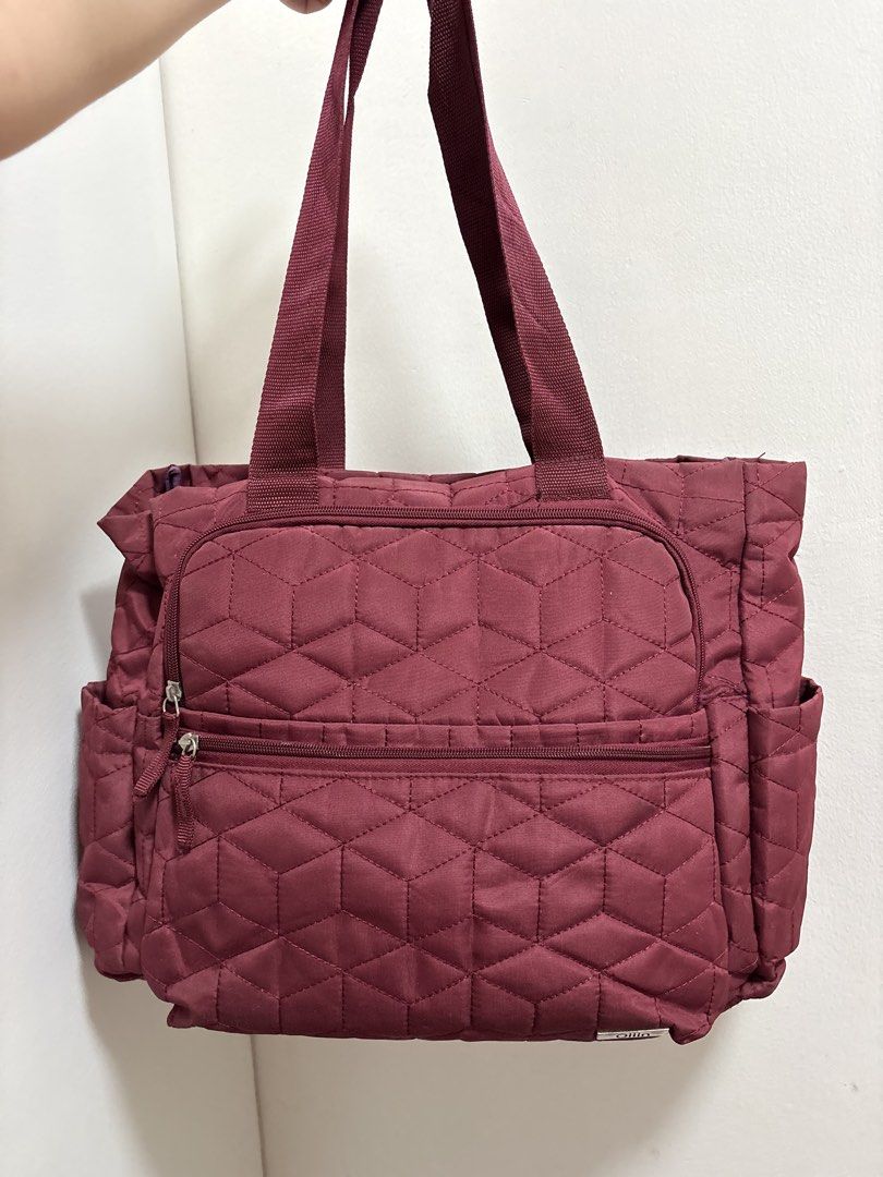 Ollin Quilted Baby Bag with Multiple Pockets (Category: Maternity Care) located in Cabuyao City. Submitted by mhd.i (Listing ID 1468877301, Image 1). Description: - Brand: Ollin - Color: Maroon - Design: Geometric quilted pattern with silver-tone metal brand tag - Handles: Sturdy top webbing handles - Compartments: Secure main zip closure, zippered front compartment, and a smaller zip pocket below - Pockets: Convenient side pockets on both ends f