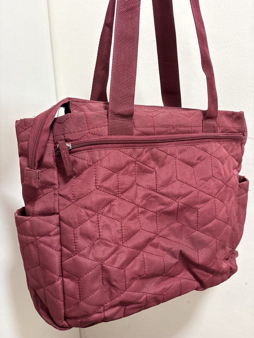 Ollin Quilted Baby Bag with Multiple Pockets (Category: Maternity Care) located in Cabuyao City. Submitted by mhd.i (Listing ID 1468877301, Image 3). Description: - Brand: Ollin - Color: Maroon - Design: Geometric quilted pattern with silver-tone metal brand tag - Handles: Sturdy top webbing handles - Compartments: Secure main zip closure, zippered front compartment, and a smaller zip pocket below - Pockets: Convenient side pockets on both ends f