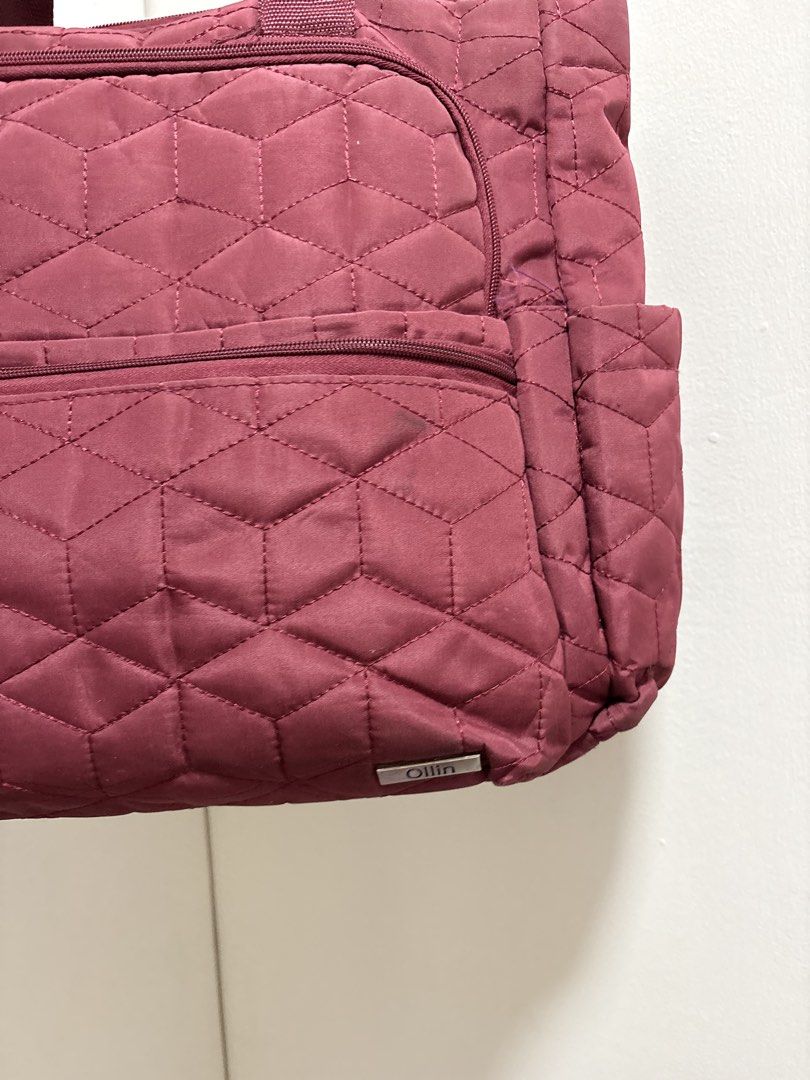 Ollin Quilted Baby Bag with Multiple Pockets (Category: Maternity Care) located in Cabuyao City. Submitted by mhd.i (Listing ID 1468877301, Image 2). Description: - Brand: Ollin - Color: Maroon - Design: Geometric quilted pattern with silver-tone metal brand tag - Handles: Sturdy top webbing handles - Compartments: Secure main zip closure, zippered front compartment, and a smaller zip pocket below - Pockets: Convenient side pockets on both ends f