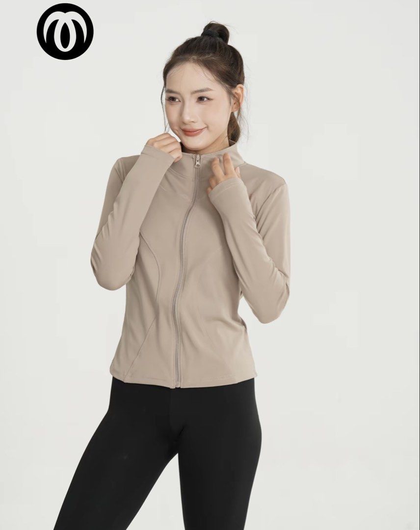 Omcore jacket (Category: Coats, Jackets and Outerwear) located in Cheras. Submitted by iqa___ (Listing ID 1468782832, Image 1). Description: - Color: Taupe - Style: Athletic zip-up jacket with a fitted silhouette - Features: Stand-up collar, full front zipper, and thumbholes at the cuffs - Details: Flattering curved seam lines along the torso - Material: Lightweight and stretchy activewear fabric - Condition: Brand new / Excellent (ready to wear)