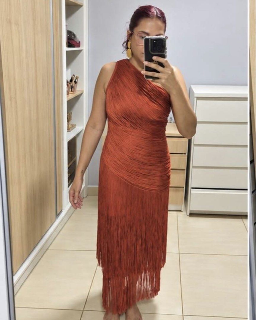 One shoulder burnt orange / rust fringe gown (Category: Dresses) located in Paranaque City. Submitted by leemillz (Listing ID 1468859887, Image 3). Description: Super unique fringe gown! Color: Rust orange Style: Asymmetric one-shoulder with fitted bodice and tiered fringe overlay Length: Midi length with a chic split hem Closure: Back zipper for easy wear Condition: Worn once for a wedding and got tonssss of compliments for a unique wedding gues