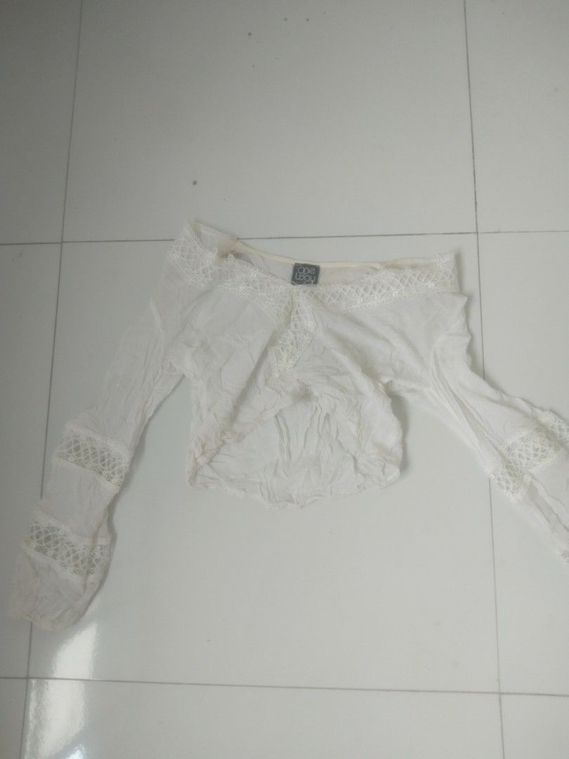 One Way white off-shoulder lace top (Category: Blouses) located in Manila. Submitted by gentlephoenix.339381 (Listing ID 1468744597, Image 1). Description: - Brand: One Way - Color: Off-white - Style: Off-shoulder, cropped length - Details: Long sleeves with lace panel accents and matching lace trim along the neckline - Fabric: Lightweight and comfortable - Occasion: Casual wear, great for warm days out.