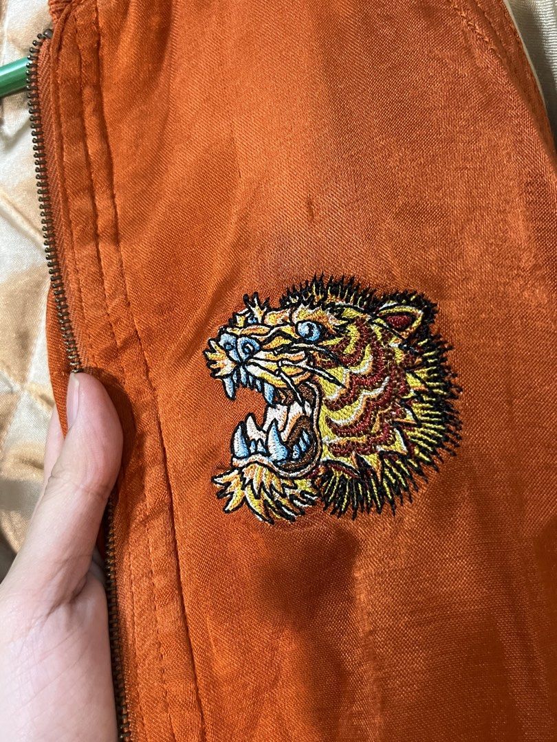 Orange Bomber Jacket (Category: Coats, Jackets and Outerwear) located in Marikina City. Submitted by yssacee (Listing ID 1468904000, Image 1). Description: - comfy, warm material, feels soft - great quality - fits XS, S unisex - PM for more pics/size inquiries - cute embroidered detail of Tiger - shipping from lower Antipolo Rizal.
