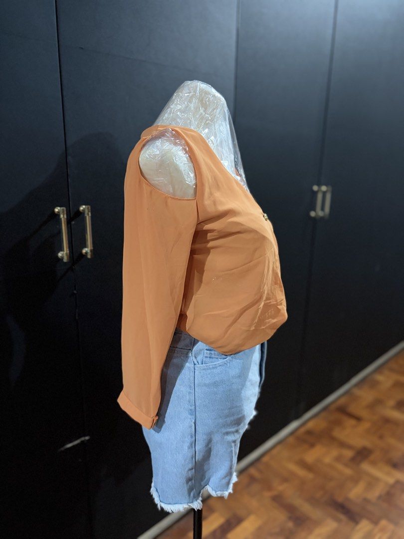 Orange Cold Shoulder Wrap Blouse (Category: Blouses) located in Manila. Submitted by everydaymeanseveryday (Listing ID 1468865371, Image 2). Description: - Color: Vibrant Orange - Style: Cold-shoulder long-sleeve blouse with V-neck wrap front - Details: Features a single decorative center button - Fabric: Lightweight with a relaxed, flowy drape - Condition: Clean, excellent, and ready to wear - Perfect for: Casual day outs, pairs great with denim
