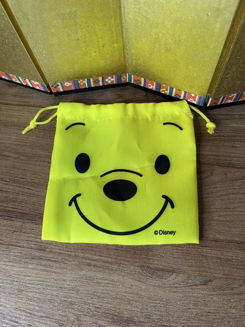 Original Disney Winnie the Pooh Yellow Drawstring Pouch (Category: Purses & Pouches) located in Gapan. Submitted by lunashop14 (Listing ID 1468716251, Image 1). Description: - Item: Winnie the Pooh Drawstring Pouch - Color: Bright yellow with textured weave fabric - Design: Cute Pooh face graphic on the front with subtle Disney copyright print - Closure: Dual yellow drawstring cords on both sides - Condition: Clean interior and exterior, well-mai