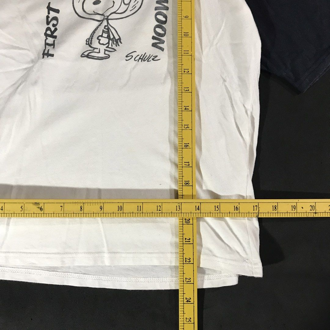 Peanuts Snoopy “First Beagle On The Moon” Raglan Shirt (Category: Tshirts & Polo Shirts ) located in Manila. Submitted by a_aron.f6e3a7 (Listing ID 1468786028, Image 3). Description: Size: Small Color rate: 9/10 (White body with Navy Blue sleeves and graphic print) Condition: Good pre-owned condition Issues: Visible wrinkles and creases from storage; no visible major holes or tears.