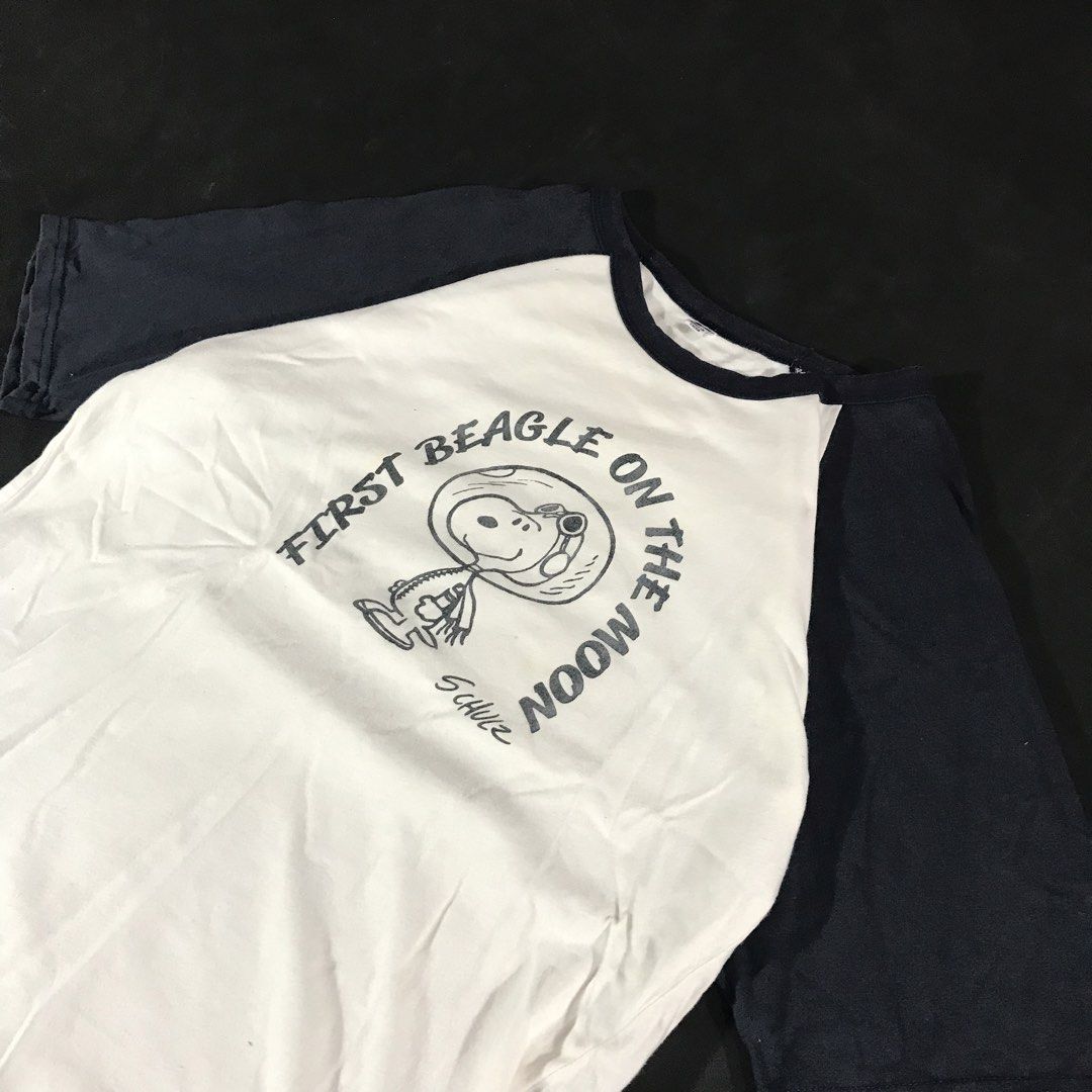 Peanuts Snoopy “First Beagle On The Moon” Raglan Shirt (Category: Tshirts & Polo Shirts ) located in Manila. Submitted by a_aron.f6e3a7 (Listing ID 1468786028, Image 2). Description: Size: Small Color rate: 9/10 (White body with Navy Blue sleeves and graphic print) Condition: Good pre-owned condition Issues: Visible wrinkles and creases from storage; no visible major holes or tears.