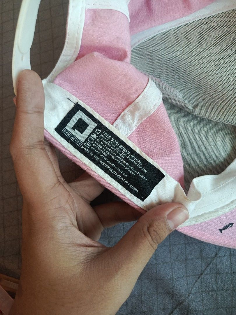Penshoppe Pink Fish Bone Cap (Category: Coats, Jackets and Outerwear) located in Malasiqui. Submitted by shop.bea (Listing ID 1468720048, Image 2). Description: - Brand: Penshoppe - Color: Light pink - Material: Comfortable cotton - Design: Small fish bone embroidery on the front panel - Fit: Adjustable strap at the back (Free size) - Care Instructions: Hand wash only.