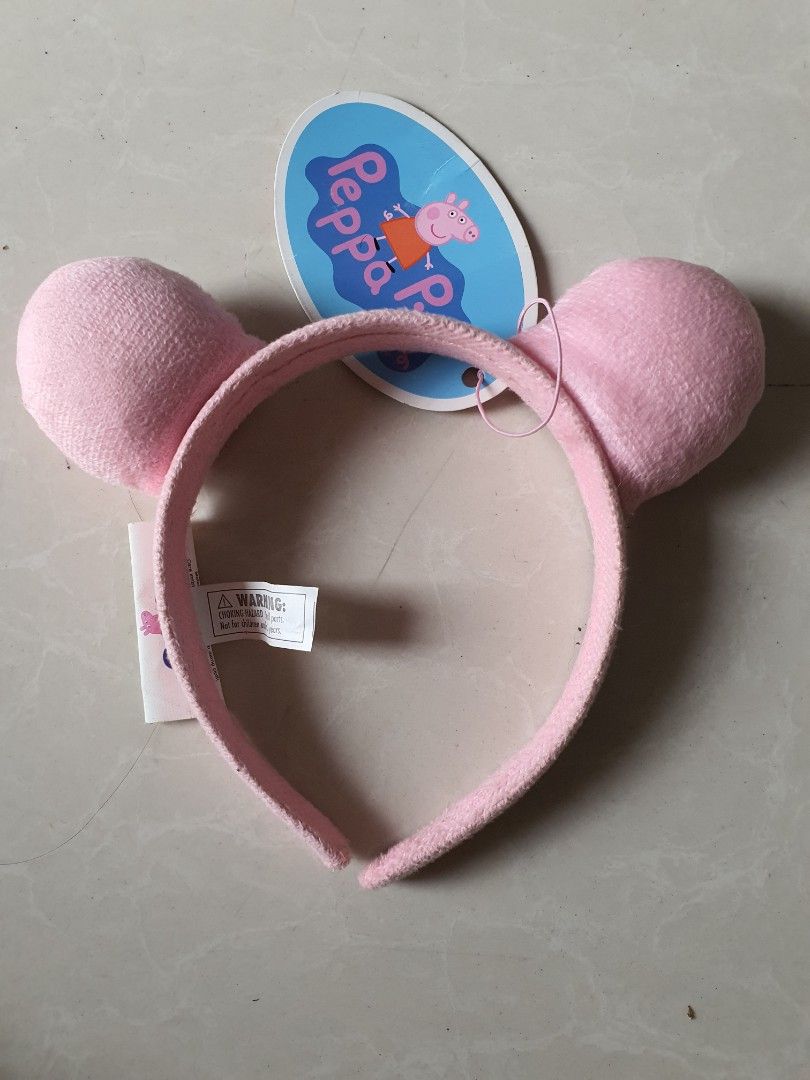 Peppa Pig Plush Ears Headband (Category: Hair Accessories) located in Meycauayan. Submitted by shoptoown (Listing ID 1468756504, Image 1). Description: - Official Peppa Pig merchandise by Astley Baker Davies Ltd - Features cute pink plush round ears on top - Brand new with original tag still attached - Made with soft, comfortable fabric material - Perfect gift or accessory for Peppa Pig fans.