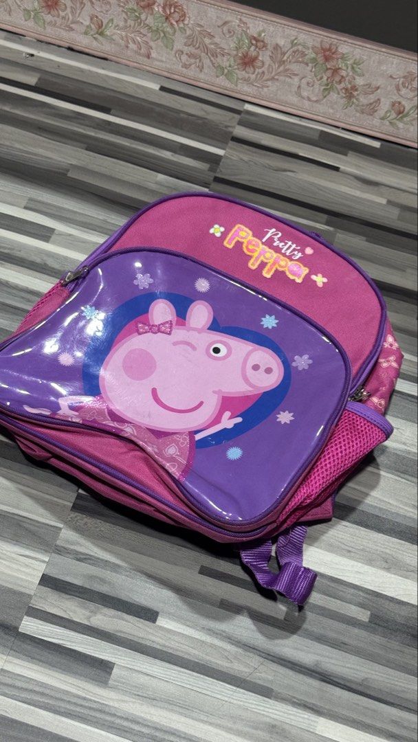 Peppa Pig Pretty Peppa Pink Purple Backpack (Category: Backpacks) located in Manila. Submitted by strk.24 (Listing ID 1468769490, Image 1). Description: - Authentic Peppa Pig design with 'Pretty Peppa' text and flower accents - Eye-catching pink and purple colorway with a shiny front pocket - Perfect size for preschool, daycare, or daily use - Features comfortable adjustable purple shoulder straps - Practical side mesh pockets for water bottles.