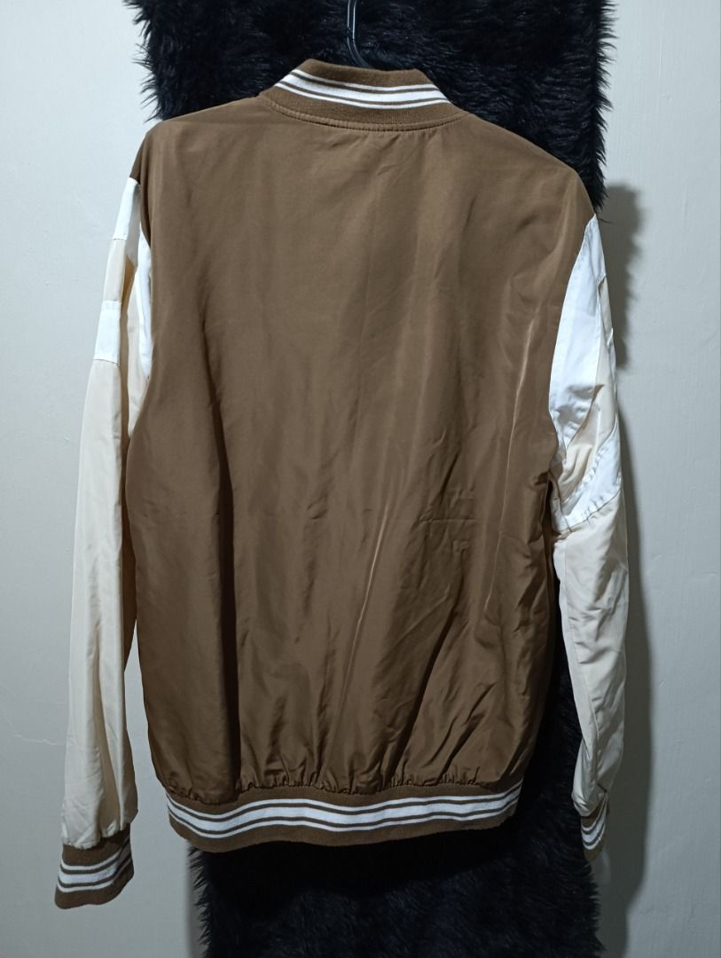 Petrol Industries Brown White Bomber Jacket Size M (Category: Coats, Jackets and Outerwear) located in Iloilo. Submitted by jpk_ok_sales (Listing ID 1468808489, Image 3). Description: - Brand: Petrol Industries - Style: Brown and white bomber jacket - Size: Medium (tag inside collar) - Closure: Snap buttons down the front - Details: Large white chest graphics with script lettering - Pockets: Two front welt pockets - Trim: Striped ribbed cuffs and
