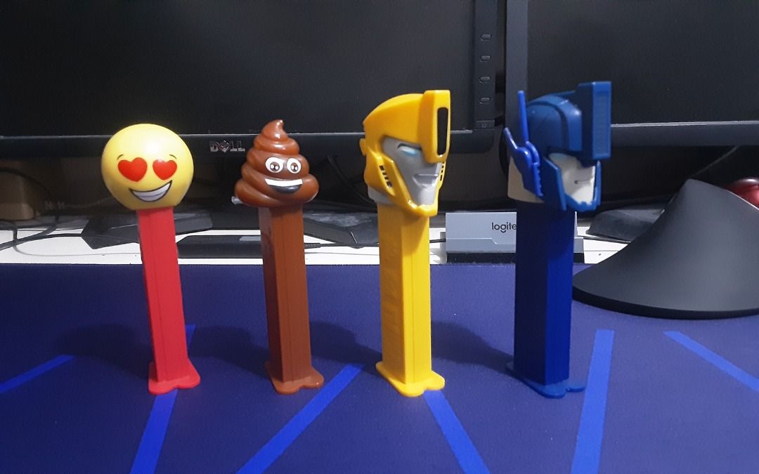 PEZ Candy Dispensers (Category: Character Goods) located in Quezon City. Submitted by bobbyrey2 (Listing ID 1468795738, Image 1). Description: PEZ Candy Dispensers Like New, On-Display Only. Set Includes: Transformers Animated - Optimus Prime Transformers Animated - Bumblebee Pou (Tae/Poop) In-Love Imoji PhP 250.00 only for the set (Negotiable. Usap tayo, offer lang. Yung reasonable sana, wag buraot please). RFS: Decluttering ACTUAL ITEMS SHOWN. 