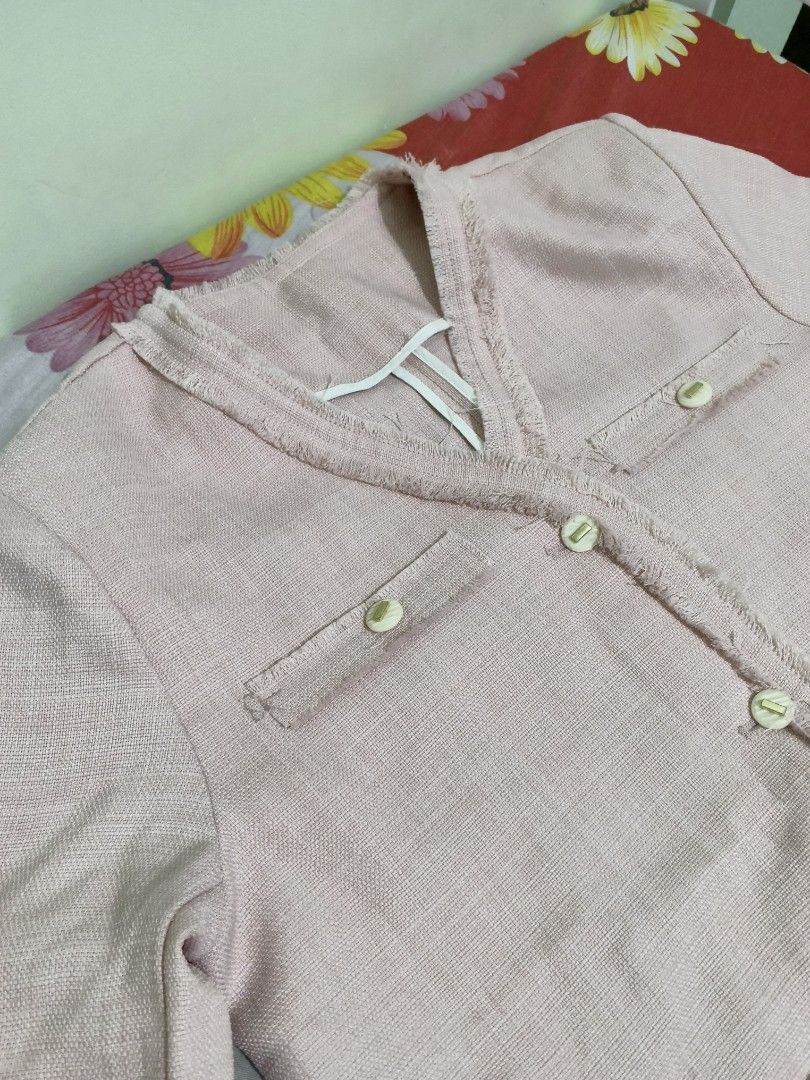 Pink Button-Front Blouse with Fringe Trim (Category: Blouses) located in Makati City. Submitted by kawaiilily_23 (Listing ID 1468929989, Image 1). Description: - Color: Light pink with cream and gold-detail buttons - Sleeves: Short sleeves with trendy frayed trim - Design: Structured collarless V-neck - Pockets: 2 functional front pockets with flaps - Fabric: Clean, textured weave material - Condition: Excellent - 450.