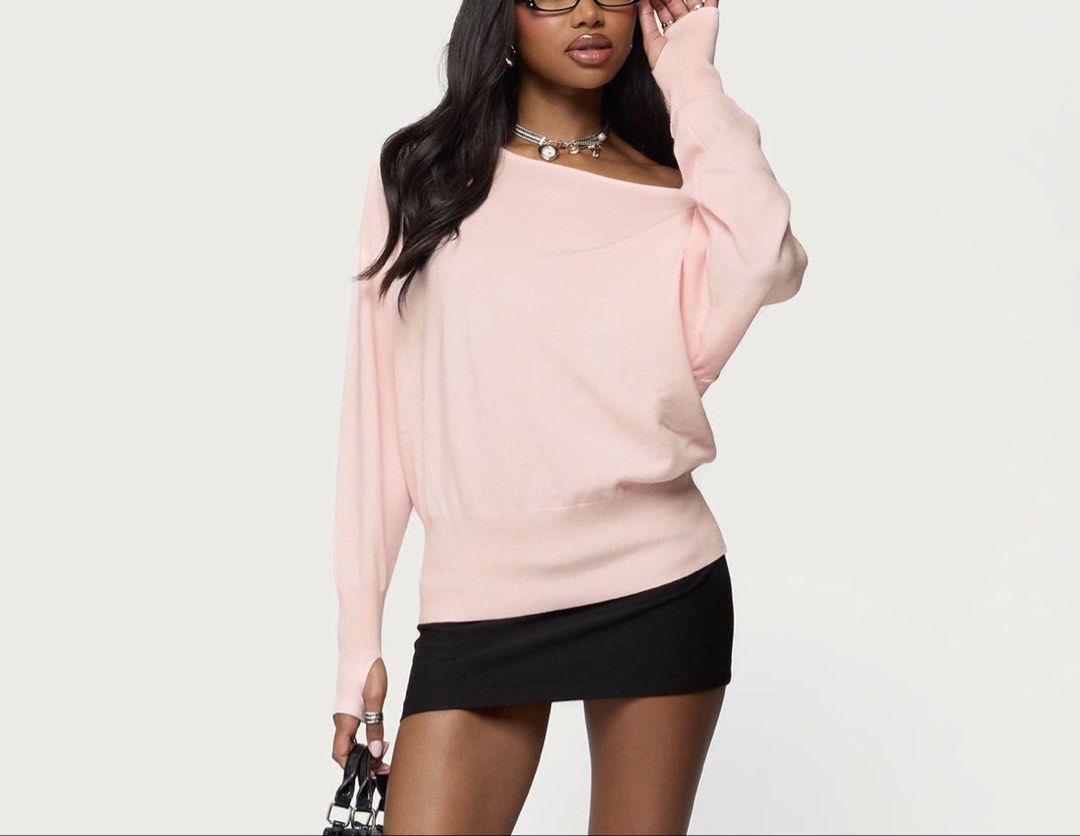 Pink Off-Shoulder Knit Sweater (Category: Longsleeves) located in Taguig. Submitted by lrichdeclutters.mnl (Listing ID 1468927163, Image 2). Description: - Color: Soft pink - Style: Asymmetrical off-the-shoulder neckline - Details: Long sleeves with convenient thumbholes - Fit: Relaxed body with a ribbed waist hem (oversized fit) - Material: Lightweight knit.