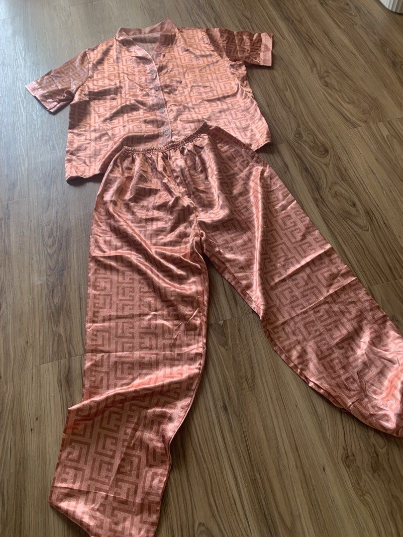Pink Satin Geometric Pattern Short Sleeve Pajama Set (Category: Undergarments & Loungewear) located in Antipolo. Submitted by Sparkle111 (Listing ID 1468715673, Image 3). Description: - Pink satin pajama set featuring an all-over geometric pattern - Short sleeve button-down top with neat white buttons - Matching pants with a comfortable elastic waistband - Silky smooth, lightweight material - Perfect for sleeping or cozy days at home.
