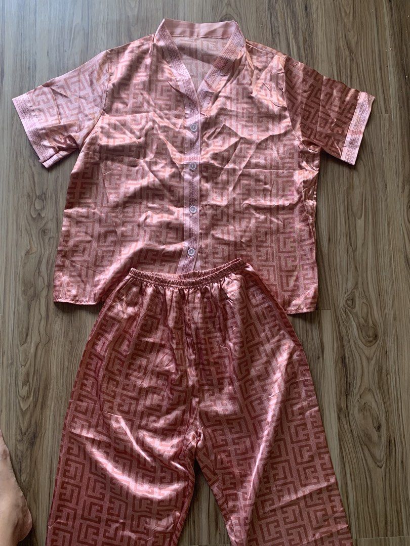 Pink Satin Geometric Pattern Short Sleeve Pajama Set (Category: Undergarments & Loungewear) located in Antipolo. Submitted by Sparkle111 (Listing ID 1468715673, Image 1). Description: - Pink satin pajama set featuring an all-over geometric pattern - Short sleeve button-down top with neat white buttons - Matching pants with a comfortable elastic waistband - Silky smooth, lightweight material - Perfect for sleeping or cozy days at home.