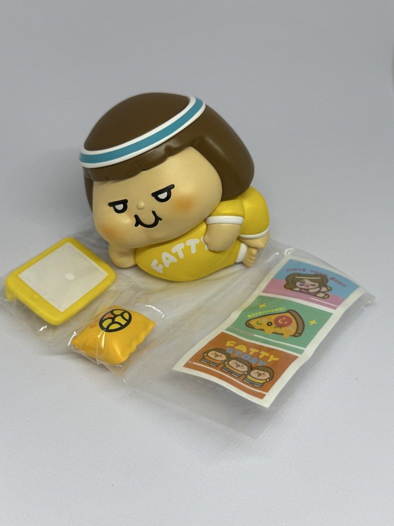 Plastic Thing Fatty Collectible Figure Blind Box Set (Category: Designer & Blind Box Toys) located in Las Pinas. Submitted by silverfalcon_dbc769 (Listing ID 1468777049, Image 2). Description: - Character: Plastic Thing Fatty (Yellow theme) - Condition: Opened for photos only, all small parts still factory-sealed in plastic wrappers - Inclusions: Tiny phone, little pillow, stickers, and original foil packaging bag - Perfect for collectors and fan