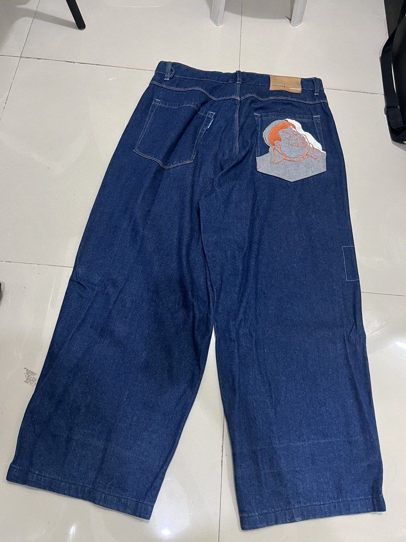 Platinum FUBU Fat Albert RARE (Category: Jeans) located in Manila. Submitted by an0_na (Listing ID 1468890780, Image 2). Description: - Brand: Platinum FUBU - Style: Vintage dark wash wide leg, baggy fit denim jeans - Details: Fat Albert character graphic embroidery on back pocket and front leg - Interior: All-over printed inner lining with branded waistband - Size: Tagged W38 L34 (Measures approx. 19 inches across the waist laid flat).