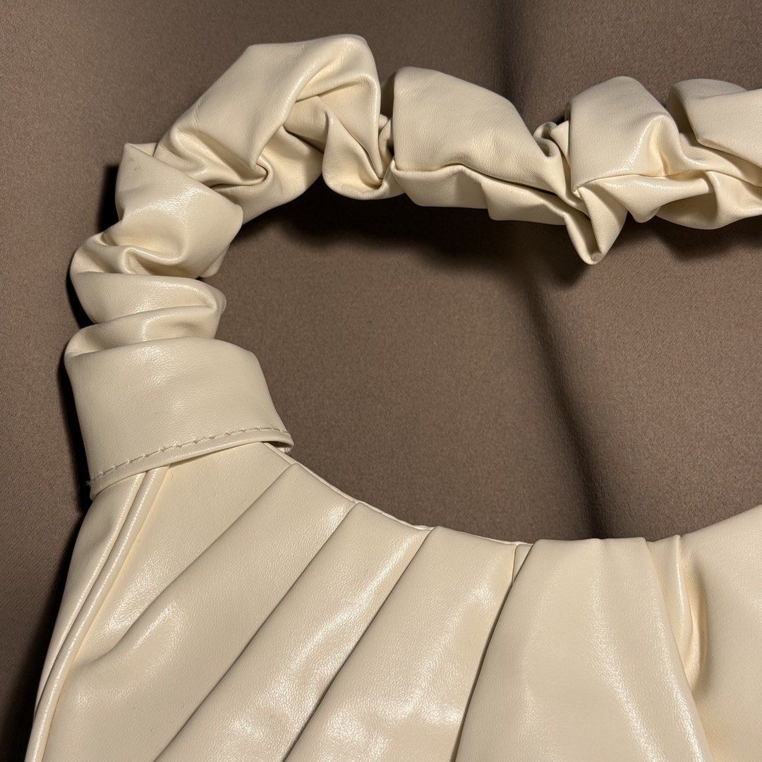 Pleated Ruched Scrunchie Shoulder Bag – Cream / Off-White (Category: Purses & Pouches) located in Manila. Submitted by cheemkenn (Listing ID 1468809321, Image 2). Description: Pleated Ruched Scrunchie Shoulder Bag – Cream / Off-White Selling a chic and trendy ruched shoulder bag in a lovely cream/off-white soft faux leather. Features elegant pleating along the body and a fashionable scrunchie-style top handle. Compact yet roomy enough for your ph
