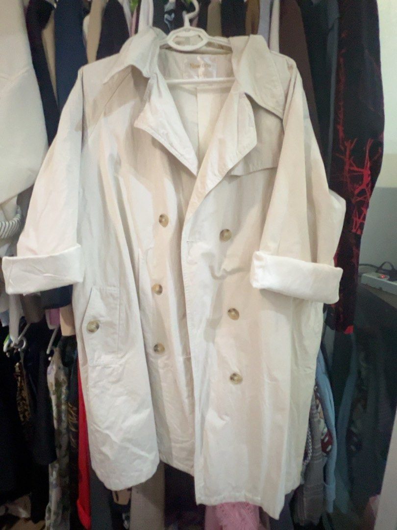 Plus size Cream Double-Breasted Trench Coat Size 46 (Category: Coats, Jackets and Outerwear) located in Quezon City. Submitted by kishey (Listing ID 1468783271, Image 2). Description: - Color: Cream - Style: Double-breasted trench coat with classic collar and front buttons - Pockets: Two functional side pockets - Details: Tailored back storm flap and center vent - Measurements: Bust 46 inches, Length 37 inches - Material: Lightweight, ideal for e