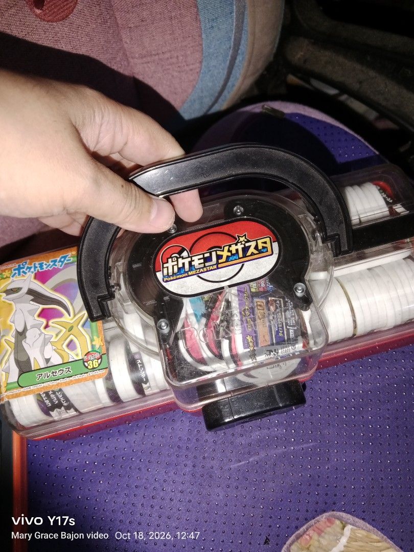 Pokemon Mezastar Storage Case with Multiple Tags (Category: Character Goods) located in Muntinlupa City. Submitted by periwinklefairy23 (Listing ID 1468747866, Image 1). Description: - Includes a red and clear plastic storage case with a portable handle and secure latches - Filled with an assortment of Japanese Pokemon Mezastar tags - Features various creature tags, including Arceus - Perfect bundle for players looking for extra storage and tag v