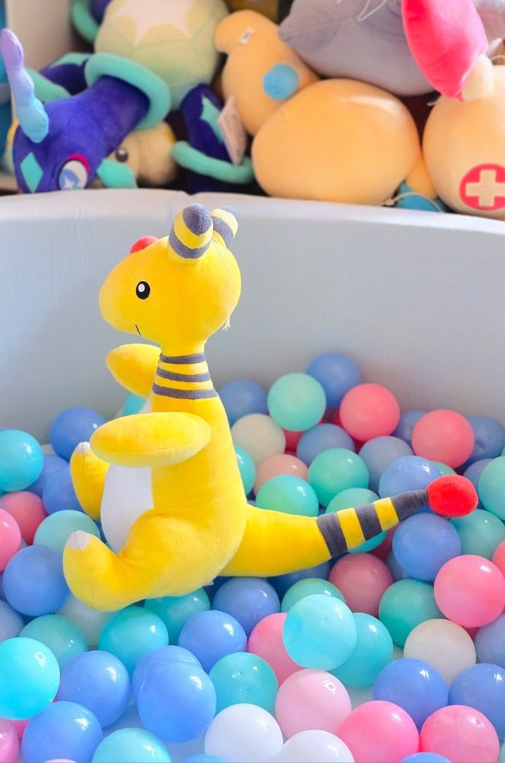 Pokémon Ampharos Plush (Category: Plushies & Soft Toys) located in Paranaque City. Submitted by vanchris84 (Listing ID 1468813846, Image 2). Description: - Adorable yellow and white Ampharos plush toy in a sitting position - Banpresto etiketa - Features iconic grey stripes on ears and tail with a red forehead orb - Made with ultra-soft, clean, and fluffy material - Stubby arms and feet for extra cuteness - Perfect addition to any Pokémon collecti
