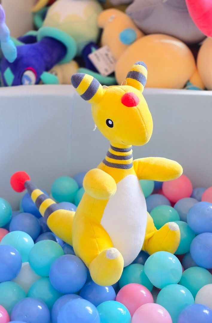 Pokémon Ampharos Plush (Category: Plushies & Soft Toys) located in Paranaque City. Submitted by vanchris84 (Listing ID 1468813846, Image 1). Description: - Adorable yellow and white Ampharos plush toy in a sitting position - Banpresto etiketa - Features iconic grey stripes on ears and tail with a red forehead orb - Made with ultra-soft, clean, and fluffy material - Stubby arms and feet for extra cuteness - Perfect addition to any Pokémon collecti
