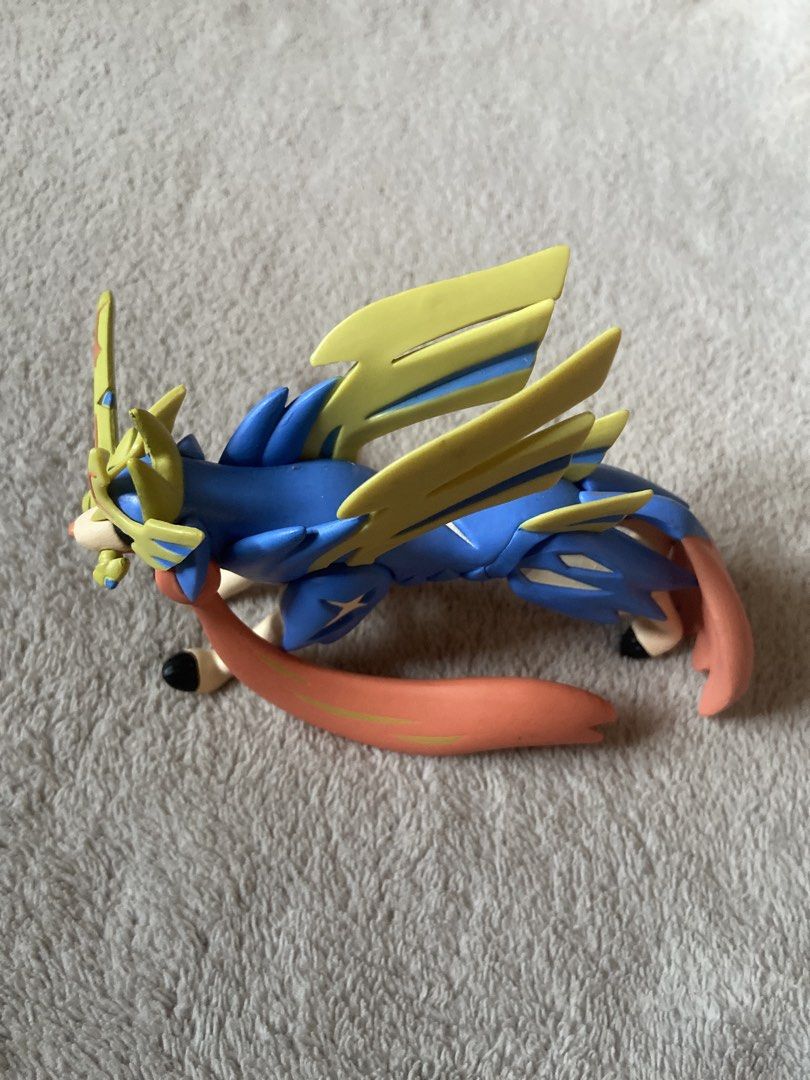 Pokémon Zacian Crowned Sword Tomy Figure (Category: Figurines & Statues) located in Davao. Submitted by mengsmixitems (Listing ID 1468715182, Image 1). Description: - Brand: Tomy (Official Nintendo stamp on underside) - Character: Zacian (Crowned Sword Form) - Colors: Blue and gold design - Condition: Stands well on display - Ideal for Pokémon collections.
