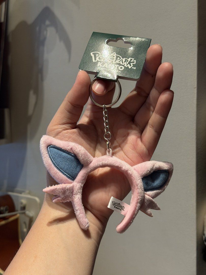 Poképark Kanto Espeon Headband Keychain Plush (Category: Character Goods) located in Santa Maria. Submitted by itsvener (Listing ID 1468745477, Image 1). Description: - Authentic Poképark Kanto merchandise - Cute pink headband plush design with blue inner ears - Complete with metal ring and chain attachment - Brand new and unused with original header card - Store packaging intact with side branded tag.
