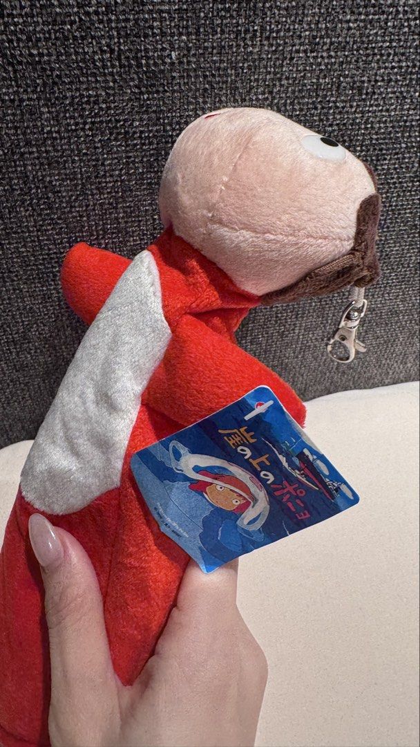 Ponyo Sosuke Plush Pencil Case (Category: Plushies & Soft Toys) located in Mandaluyong City. Submitted by maelovestoshop (Listing ID 1468870122, Image 2). Description: - Official Studio Ghibli Ponyo merchandise featuring Sosuke - Soft red and white plush material with detailed facial embroidery and brown hair - Secure zipper closure running down the back - Equipped with an attached metal keyring clip for easy bag attachment - Comes with the origi