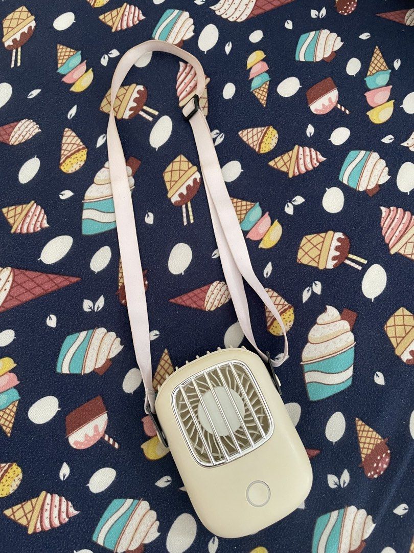 Portable Hanging Neck Fan with Strap Rechargeable (Category: Fans) located in Quezon City. Submitted by simply_closet (Listing ID 1468822853, Image 1). Description: Color: Cream with a cute adjustable pink lanyard strap RFS: Declutter MOP: Gcash/bank transfer.