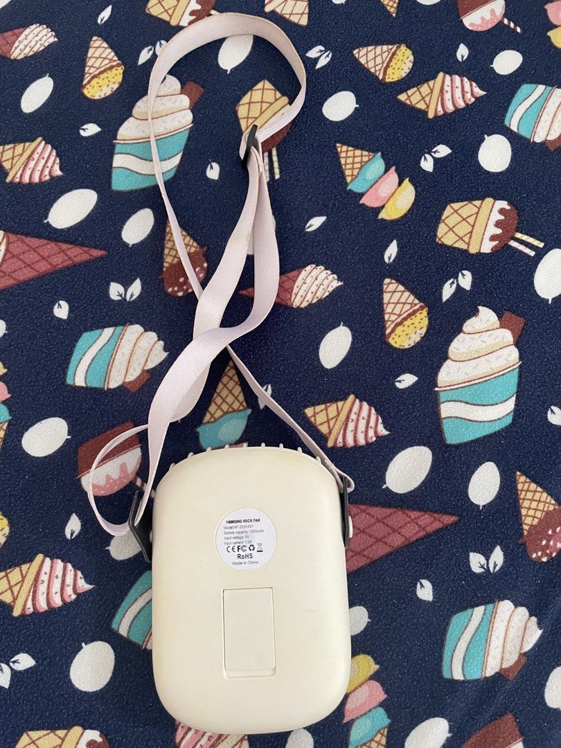 Portable Hanging Neck Fan with Strap Rechargeable (Category: Fans) located in Quezon City. Submitted by simply_closet (Listing ID 1468822853, Image 2). Description: Color: Cream with a cute adjustable pink lanyard strap RFS: Declutter MOP: Gcash/bank transfer.