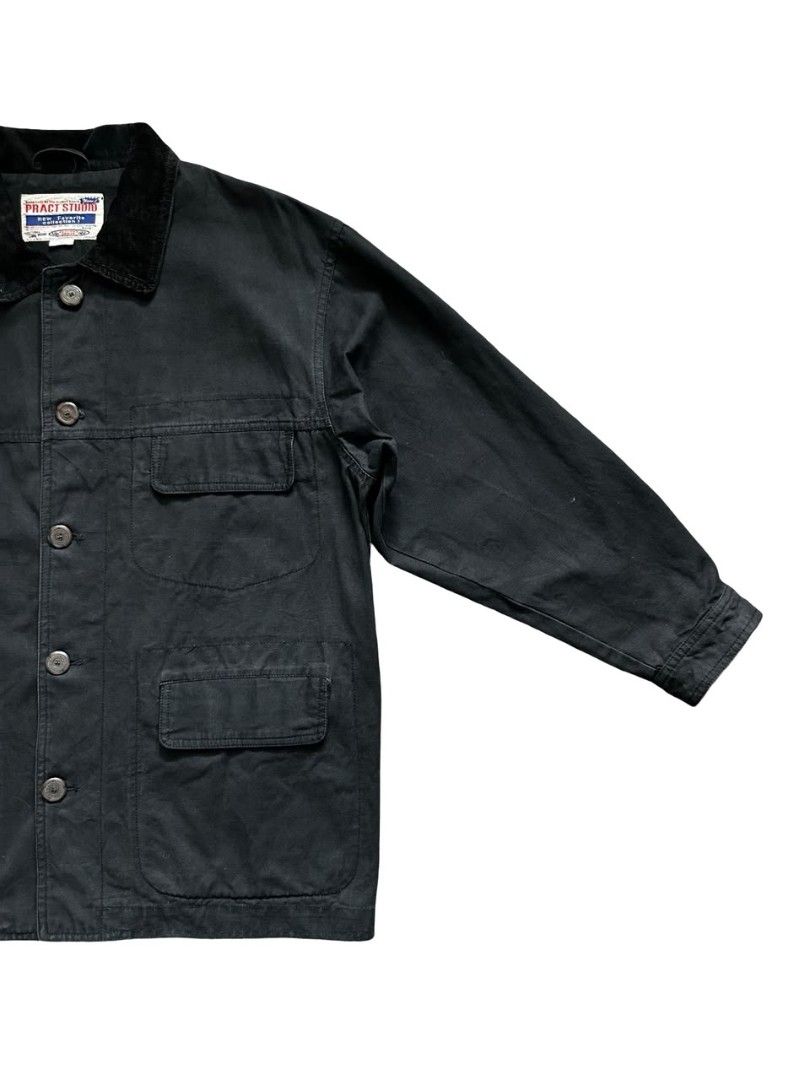 Pract Studio Chore Jacket (Category: Coats, Jackets and Outerwear) located in Johor Bahru. Submitted by gselective (Listing ID 1468721068, Image 3). Description: Faded black cotton workwear jacket with a corduroy collar, branded buttons and three flap pockets. Relaxed, boxy cut. Tagged M. 100% cotton outer. Pre-owned with fading, light wear and loose threads. Measurements shown in photos. Ships from Johor Bahru. Postage separately. Please refer t