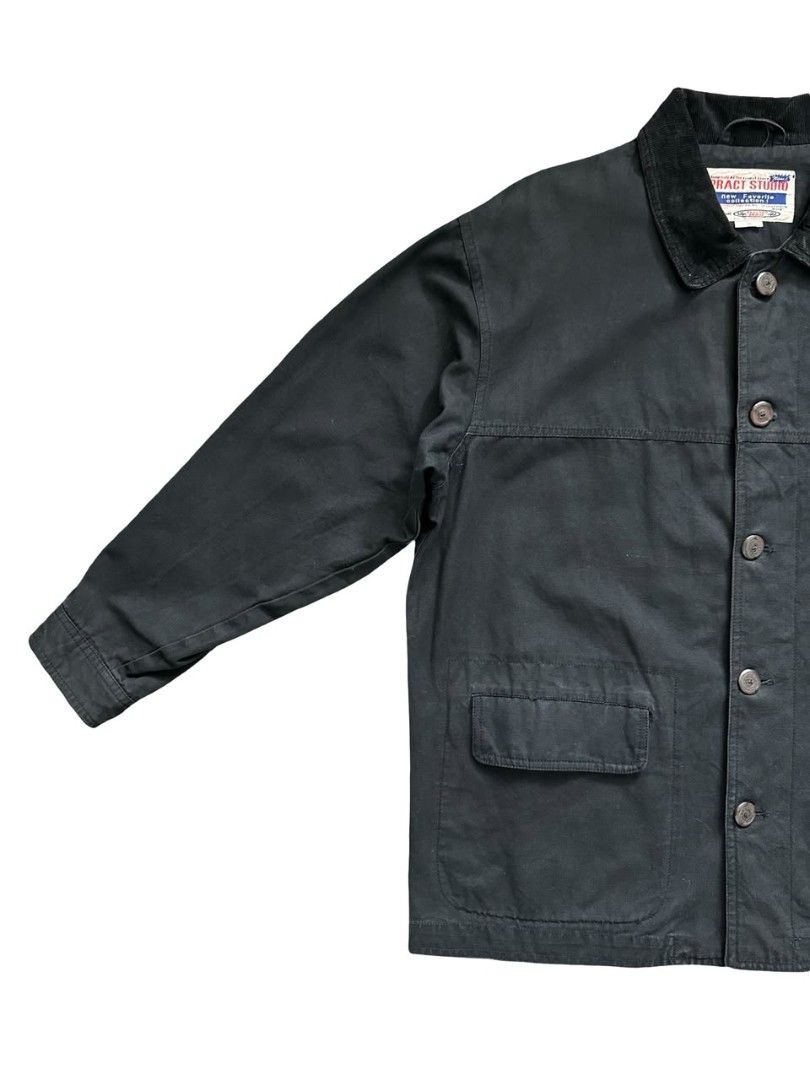 Pract Studio Chore Jacket (Category: Coats, Jackets and Outerwear) located in Johor Bahru. Submitted by gselective (Listing ID 1468721068, Image 2). Description: Faded black cotton workwear jacket with a corduroy collar, branded buttons and three flap pockets. Relaxed, boxy cut. Tagged M. 100% cotton outer. Pre-owned with fading, light wear and loose threads. Measurements shown in photos. Ships from Johor Bahru. Postage separately. Please refer t