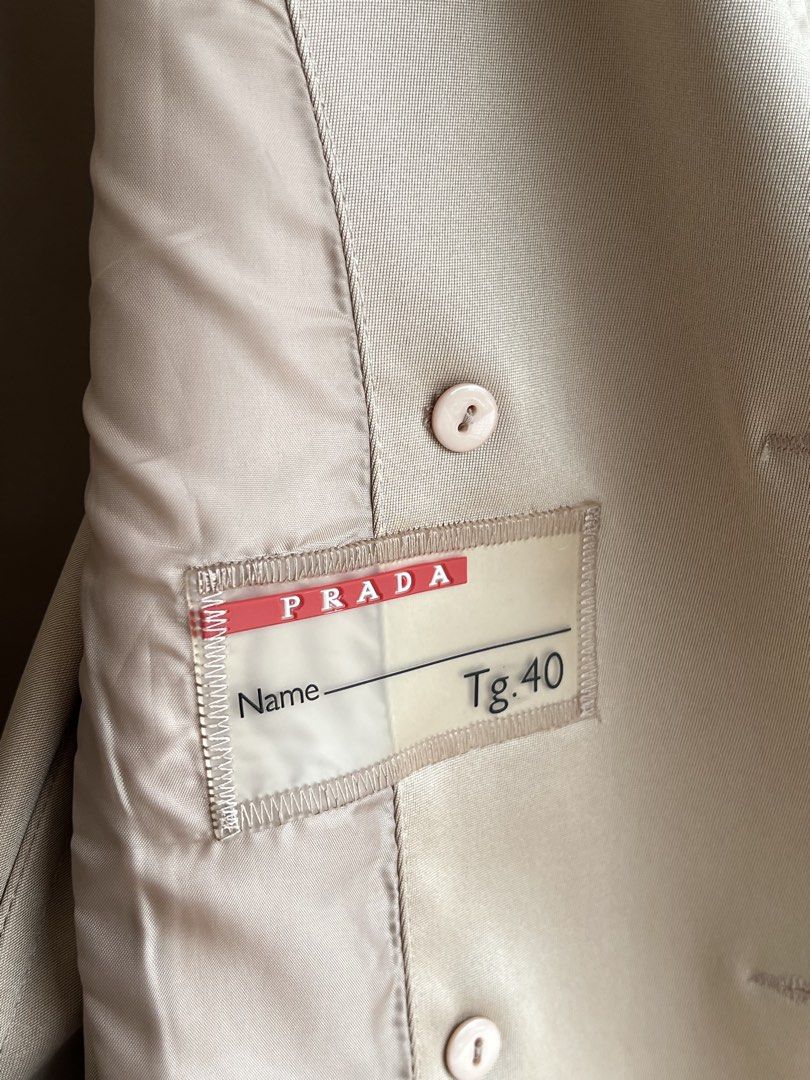 PRADA - DOUBLE BREASTED TRENCH COAT (Category: Coats, Jackets and Outerwear) located in Bacolod City. Submitted by timelessbyjosh (Listing ID 1468822565, Image 3). Description: BEST FOR COZY & COLD WEATHER OUTFITS SIZE : ACTUAL COLOR : TAN COLOR RATE : 9. 5 OUT OF 10 CONDITION : EXCELLENT MATERIAL : MADE IN : FLAWS : NONE DIMENSIONS LENGTH - 30 WIDTH ( ARMPIT TO ARMPIT )- 17. 5 WAIST - 38 MEASUREMENT TAKEN WHILE LAYING FLAT. PLEASE COMPARE THE ME