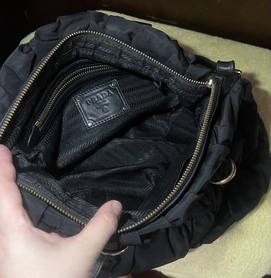 Prada Black Ruched Tote Bag - PROJECT bag!!! (Category: Luxury Bags & Wallets) located in Daraga. Submitted by pickandgo26 (Listing ID 1468767801, Image 3). Description: Clean inside and out. Missing handles and sling and one zipper puller of the main compartment. Lampo zip Pls see actual pics for reference..